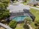 Screened-in pool and lush landscaping with a privacy fence surround this lovely home at 113 Candlewood Ct, Kissimmee, FL 34743