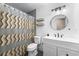 Nicely updated bathroom featuring decorative shower curtain, modern fixtures, and a vanity with a round mirror at 113 Candlewood Ct, Kissimmee, FL 34743