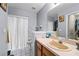 Bathroom featuring a large vanity, an oversized mirror, and a window for natural light at 113 Candlewood Ct, Kissimmee, FL 34743