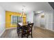 Inviting dining room with contemporary lighting, ample seating, and a serene ambiance at 113 Candlewood Ct, Kissimmee, FL 34743