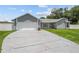 Charming one story home featuring a two-car garage, mature landscaping, and a long driveway at 113 Candlewood Ct, Kissimmee, FL 34743