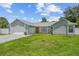Well maintained single-story home with a spacious driveway and lawn, featuring a lovely front door at 113 Candlewood Ct, Kissimmee, FL 34743