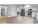 Kitchen featuring modern stainless steel appliances, white cabinets, and bright flooring at 113 Candlewood Ct, Kissimmee, FL 34743