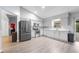 Bright kitchen with white cabinets, stainless steel appliances, and new flooring at 113 Candlewood Ct, Kissimmee, FL 34743