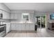 Bright kitchen with white cabinets, stainless appliances, and sliding door access at 113 Candlewood Ct, Kissimmee, FL 34743