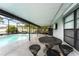 Covered patio features outdoor seating and dining near the screened pool area at 113 Candlewood Ct, Kissimmee, FL 34743