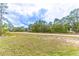 Picture of a quiet lot with many trees on a sunny day at 13 Oak Trail Pl, Ocala, FL 34472