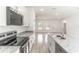 A modern kitchen featuring granite countertops, a sink island, and stainless steel appliances at 13 Oak Trail Pl, Ocala, FL 34472