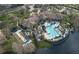 An aerial view shows the community pool, clubhouse, bocce ball court, and nearby lake at 1357 Venezia Ct # 302, Davenport, FL 33896