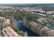 Beautiful aerial view of the community with a lake, mature trees, and several buildings with parking at 1357 Venezia Ct # 302, Davenport, FL 33896