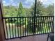 Relaxing screened balcony view features a serene pond surrounded by lush landscaping at 1357 Venezia Ct # 302, Davenport, FL 33896