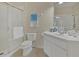 Bright bathroom featuring a vanity with sink, a toilet, and a glass-enclosed shower at 1357 Venezia Ct # 302, Davenport, FL 33896