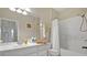 Well-lit bathroom featuring a vanity, toilet, and shower/tub combination with white finishes at 1357 Venezia Ct # 302, Davenport, FL 33896