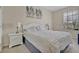 Bright bedroom featuring a queen-sized bed, a nightstand, and a sunny window at 1357 Venezia Ct # 302, Davenport, FL 33896