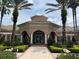Clubhouse exterior view with palm trees at 1357 Venezia Ct # 302, Davenport, FL 33896