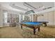 This game room features two pool tables and ample seating, great for friendly competition and relaxation at 1357 Venezia Ct # 302, Davenport, FL 33896