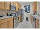 Kitchen featuring stainless steel appliances and light wood cabinets at 1357 Venezia Ct # 302, Davenport, FL 33896