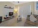 Cozy living room with modern entertainment center and sliding door to patio at 1357 Venezia Ct # 302, Davenport, FL 33896