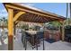 This outdoor kitchen features a large table with seating and a built-in grill, perfect for entertaining friends and Gathering at 1357 Venezia Ct # 302, Davenport, FL 33896