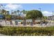Relaxing pool area with lounge chairs, lush landscaping, and palm trees at 1357 Venezia Ct # 302, Davenport, FL 33896