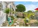 Landscaped backyard featuring a walkway, garden beds, and inviting outdoor space at 1422 Indiana Ave, St Cloud, FL 34769
