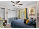 Calm bedroom with a ceiling fan, natural light, and a view of the outdoor greenery at 1422 Indiana Ave, St Cloud, FL 34769