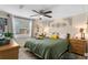 Serene bedroom with a comfortable bed, ceiling fan, natural light, and tasteful decor at 1422 Indiana Ave, St Cloud, FL 34769