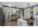 Cozy dining area with a table, chandelier, and seamless transition into the modern kitchen at 1422 Indiana Ave, St Cloud, FL 34769