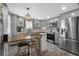 Modern kitchen with stainless steel appliances, gray cabinets, designer backsplash, and eat-in table area at 1422 Indiana Ave, St Cloud, FL 34769