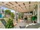 Relaxing covered patio with comfortable seating and lots of green plants and shrubbery at 1422 Indiana Ave, St Cloud, FL 34769