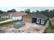 New construction home featuring a dark blue exterior, white trim, and an unfinished yard at 1522 Pine St, Orlando, FL 32824