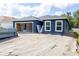 New construction home with dark blue exterior, an open garage and unfinished landscaping at 1522 Pine St, Orlando, FL 32824