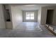 Unfinished room with neutral walls, one window and plastic on the floor at 1522 Pine St, Orlando, FL 32824
