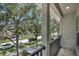 Balcony view overlooking a serene street with lush trees, sidewalks, and neighboring homes at 1607 Wilson Ave, Orlando, FL 32804