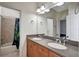 Double sink vanity with granite countertops and a tub with shower at 1607 Wilson Ave, Orlando, FL 32804