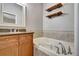 Clean bathroom features a soaking tub, wooden cabinets and a modern sink at 1607 Wilson Ave, Orlando, FL 32804
