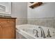 Relaxing bathroom with a large soaking tub, wood cabinets, and a tiled surround, creating a spa-like atmosphere at 1607 Wilson Ave, Orlando, FL 32804