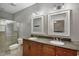 Dual vanity bathroom with modern sinks, fixtures, cabinets and a glass shower at 1607 Wilson Ave, Orlando, FL 32804