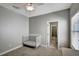 Bedroom with a ceiling fan, a crib, and a doorway to an en-suite bathroom at 1607 Wilson Ave, Orlando, FL 32804