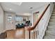 Warm entryway with hardwood floors, staircase, and a glimpse of the living room at 1607 Wilson Ave, Orlando, FL 32804