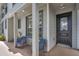 Cozy front porch features seating, an entry door, and natural lighting at 1607 Wilson Ave, Orlando, FL 32804