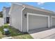 Spacious two-car garage with a neutral color, an exterior lamp, and a well maintained driveway at 1607 Wilson Ave, Orlando, FL 32804