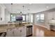 Bright, open-concept space with living area in the distance and a modern kitchen featuring granite countertops at 1607 Wilson Ave, Orlando, FL 32804