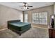 Bright main bedroom with a ceiling fan, queen bed, and natural light at 1607 Wilson Ave, Orlando, FL 32804