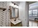 Charming powder room with wooden-framed mirror and decorative wallpaper at 1607 Wilson Ave, Orlando, FL 32804
