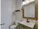 Stylish powder room featuring patterned wallpaper, modern fixtures, and a sleek vanity with a vessel sink at 1607 Wilson Ave, Orlando, FL 32804