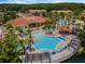 Aerial view of the resort pool, common areas, playground, and building at 195 Hideaway Beach Ln, Kissimmee, FL 34746