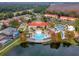 Aerial view of the resort pool, clubhouse, and common areas with picturesque lake views at 195 Hideaway Beach Ln, Kissimmee, FL 34746