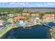 An aerial view of a resort-style community featuring a pool and lake with bridge at 195 Hideaway Beach Ln, Kissimmee, FL 34746