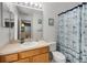 Well-lit bathroom featuring a nautical-themed shower curtain, large mirror and cream-colored countertop at 195 Hideaway Beach Ln, Kissimmee, FL 34746